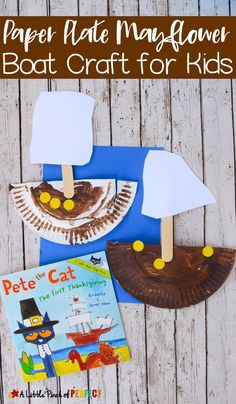 paper plate magawer boat craft for kids on a wooden table with a book