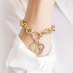 14K Yellow Round Link Charm Bracelet This Round Link Charm Bracelet is perfect for building your own heirloom bracelet. Order by itself or with charms that represent your special milestones and loved ones. Pairs perfectly with our Medium and Large Charms, as well as our Medallions! Pair with any of our loose charms and we will assemble them in-house for you! We recommend sizes medium or large, or get creative and choose one of our Falling Letter Pendants or Enamel Medallions. Product Details Link Size: 11.6 mm Weight: 7.5 inches (Solid Gold) is 9 grams (without any charms) Features a push in lock clasp Available in 14K Yellow Gold Not sure what size to order? Check out our Bracelet Sizing Guide! Comes in gift box Ships in 2 weeks (if ordered plain), 4 weeks if ordered with charms Additiona Elegant Charm Bracelet Bangle, Elegant Charm Bangle Bracelet, Elegant Yellow Gold Charm Bracelet With Removable Charms, Yellow Gold Charm Bracelet, Luxury Wedding Bracelets With Charms, Yellow Gold Round Bracelet With Charms, Anniversary Jewelry In Yellow Gold With Removable Charms, Heirloom Style Yellow Gold Charm Bracelet Gift, Anniversary Yellow Gold Jewelry With Removable Charms