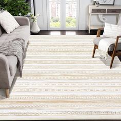 a living room filled with furniture and a white rug