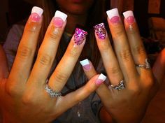 a woman with pink and white nails holding up her hands