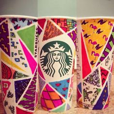 three starbucks cups with different designs on them