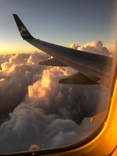 the wing of an airplane flying above clouds