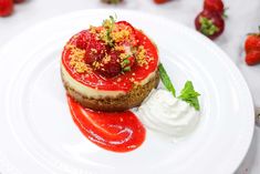 a dessert with strawberries and whipped cream on a white plate