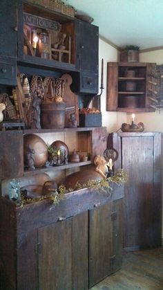 an old wooden cabinet with many items on it