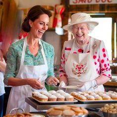 two women in aprons and hats are serving pastries to each other at a buffet