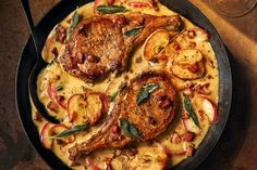 a pan filled with meat and vegetables on top of a table