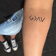 two people standing next to each other with tattoos on their arms and legs that read g v