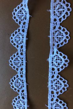 two pieces of crocheted lace on a table