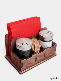 an open wooden box with two cups in it