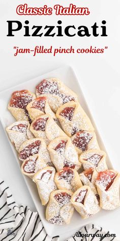 a white plate topped with pastries covered in powdered sugar on top of a zebra print table cloth