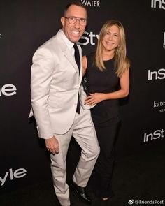 an image of a man and woman posing for the camera on the red carpet at instyle