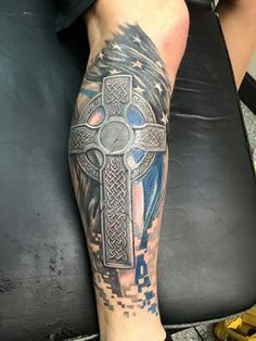 a person with a cross tattoo on their leg