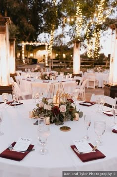 the table is set with white linens and red napkins