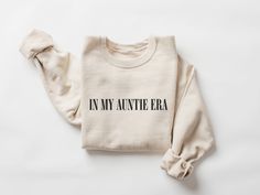 "In My Auntie Era Sweatshirt, Auntie Sweatshirt, Auntie Crewneck, Aunt Shirt, Aunt Era, Aunt Sweatshirt, Auntie Gift, Aunt Crewneck, To Be W H Y - S H O P - W I T H - S W E E T T C A P R I ? Thank you for stopping by! I'm Cassie and everything in my shop is made entirely by myself. I take pride in good quality, excellent customer service, and affordable prices. This is a unisex Gildan sweatshirt one of my favorites... Amazing quality, soft & comfortable. My products are made with a high quality heat transfer vinyl then pressed with a professional heat press... The vinyl will not flake or peel when washed. I am always here to answer any questions or concerns you may have, just send me a message! :) W HA T - Y O U - W I L L - R E C E I V E \"IN MY AUNTIE ERA\" sweatshirt in the color of your Faith Clothing, Dance Mom, Personalized Grandma, Display Picture, Mama Sweatshirt, Message Box, Nashville Tennessee, Color Charts, Embroidered Sweatshirts