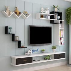 there is a television on the wall in this living room with shelving and shelves