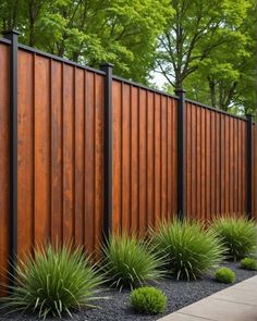 a fence that is next to some plants