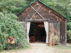 an old barn with a bicycle parked in the doorway