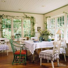 a dining room filled with lots of furniture and windows