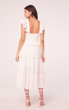 Stunning ruffle and lace details grace our ethereal dress with tiered skirt, v-neck bodice, and light as air flutter sleeves. Front tie 100% cotton Hand wash, line dry