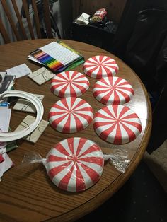 several candy canes sitting on top of a wooden table