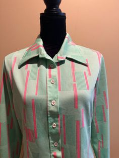 A vintage blouse in light blue with abstract pink stripes.  Cool looking longer lapels.  Long sleeves with 2 button cuffs - one of the cuffs is missing one of the two buttons.  Polyester double knit fabric - there are a few small snags in the fabric.  No rips or stains.  Tag indicates size 16.  The actual measurements are as follows; the bust measures 20 inches from armpit to armpit laying flat.  22.5 inches from shoulder to hem.  Please examine the pics, feel free to ask questions. Pink Vintage Long Sleeve Shirt, Retro Pink Long Sleeve Shirt, Vintage Pink Long Sleeve Shirt, Flannel Nightgown, Blouse Long Sleeve, Vintage Blouse, Cozy Flannel, Retro Women, Double Knit