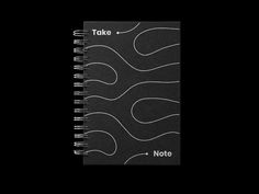 a spiral notebook with the words take note written in white ink on black paper, against a dark background