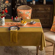 a dining room table with two plates and bowls on it