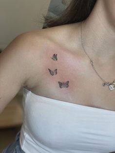 a woman with a butterfly tattoo on her chest