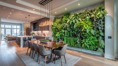 a dining room table with chairs and a green wall in the background