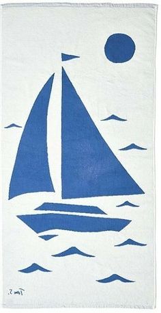 a blue and white towel with a sailboat in the ocean under a full moon