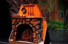 an outdoor oven made out of wood and logs