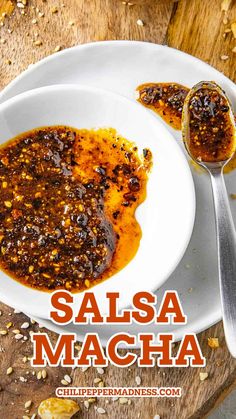 salsa macha in a white bowl on a wooden table with two spoons next to it