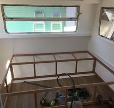 the inside of a house being built with tools and supplies on the floor next to it