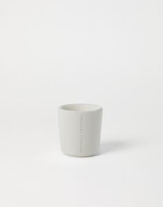 a white cup sitting on top of a table