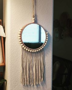 a mirror hanging on the side of a wall