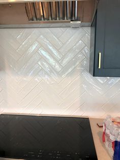 a stove top oven sitting inside of a kitchen next to a wall mounted range hood