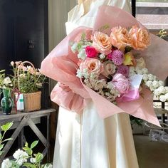 a woman holding a bouquet of flowers in her hands