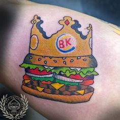 a drawing of a burger with a crown on it's head and the letter bk