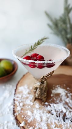 a martini glass filled with cherries and powdered sugar