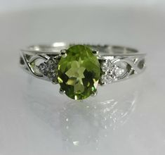 Brand : Walifine Jewellers  Material : 925 Sterling Silver  Gemstone : 100% Natural Peridot  Peridot Stone Weight : 1.10 Carat  Peridot Stone Size : 6×8 MM  Secondary stone : Cubic Zirconia  Cubic zirconia  Stone Weight : 0.06 Carat  Cubic zirconia Stone Size : 1.5 MM Gross weight : 2.57 GM Approx....  Stone Shape : Oval, Round  Ring Size : All Size Available  Benefits of Peridot:- Peridot is Known to Provide you With Good Health and Healing. You Would Gain Strength,Metabolism and Tissue and Cel Sterling Silver Promise Rings, Engagement Ring For Her, Peridot Jewelry, Peridot Stone, Peridot Gemstone, Round Rings, August Birth Stone, Rings For Her, Jaipur