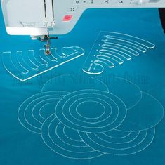 the machine is working on some circular stitching lines that are drawn onto the fabric