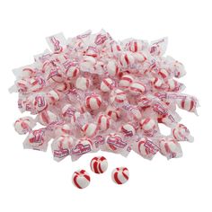 a pile of candy canes sitting next to each other on top of a white surface