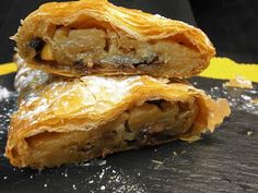 two pieces of pastry sitting on top of a table