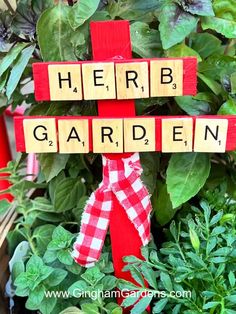 a garden sign made out of scrabble blocks with the words herb garden on it