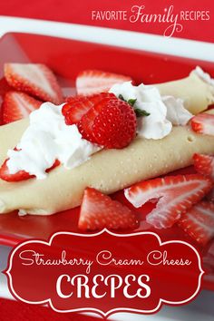 a red plate topped with strawberries and whip cream