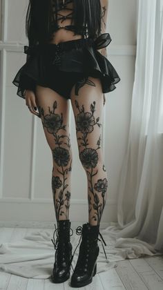 a woman with black hair and tattoos on her legs