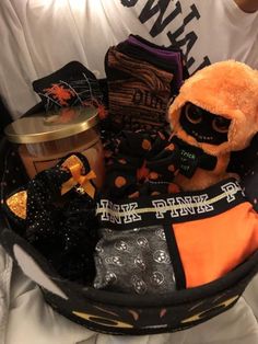 a person holding a basket filled with halloween items