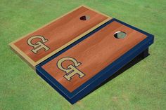 two brown and blue cornhole boards with the letters r and p painted on them