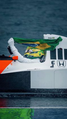 a man is sitting on top of a boat in the water