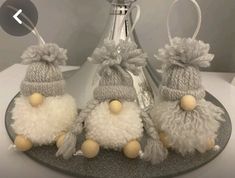 three knitted pom poms sitting on top of a plate